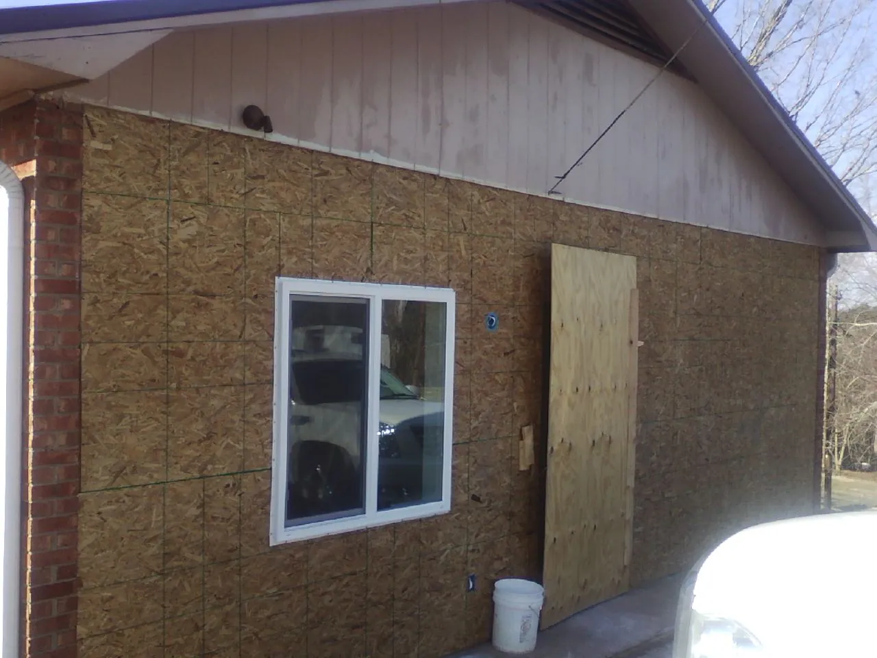 OSB sheathing on a garage addition wall before siding in Natrona Heights